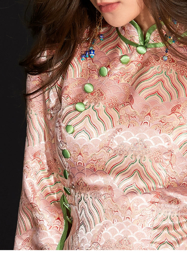 Close-up of pink Ukiyo-e cheongsam with green buttons and intricate pattern.