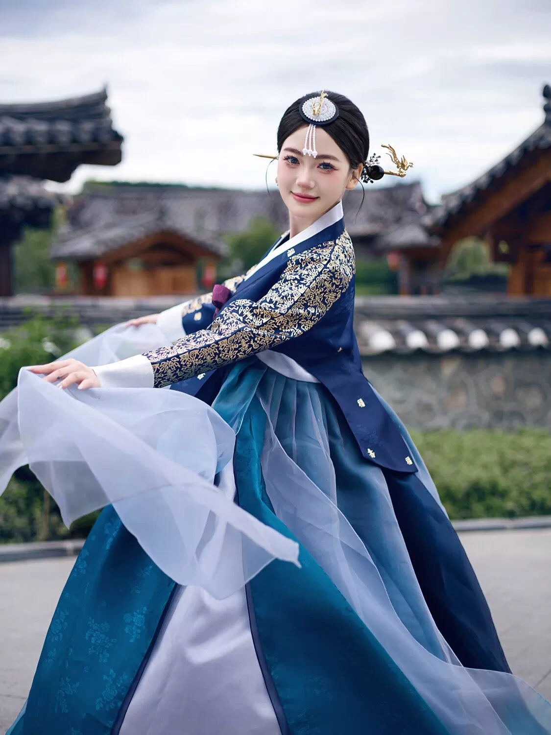 Korean woman gracefully twirling in a navy blue bronzing hanbok court dress, showcasing flowing fabric and exquisite craftsmanship.