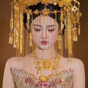 Close-up of golden curtain headdress with floral and tassel details, worn by bride in traditional Chinese wedding attire.