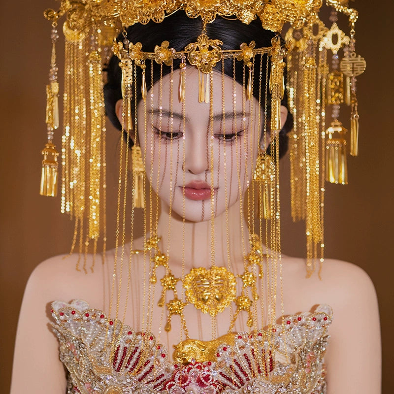 Close-up of golden curtain headdress with floral and tassel details, worn by bride in traditional Chinese wedding attire.