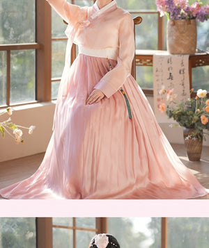 Graceful pink hanbok dress with a flowing skirt and traditional jeogori top. A sophisticated choice for cultural events.