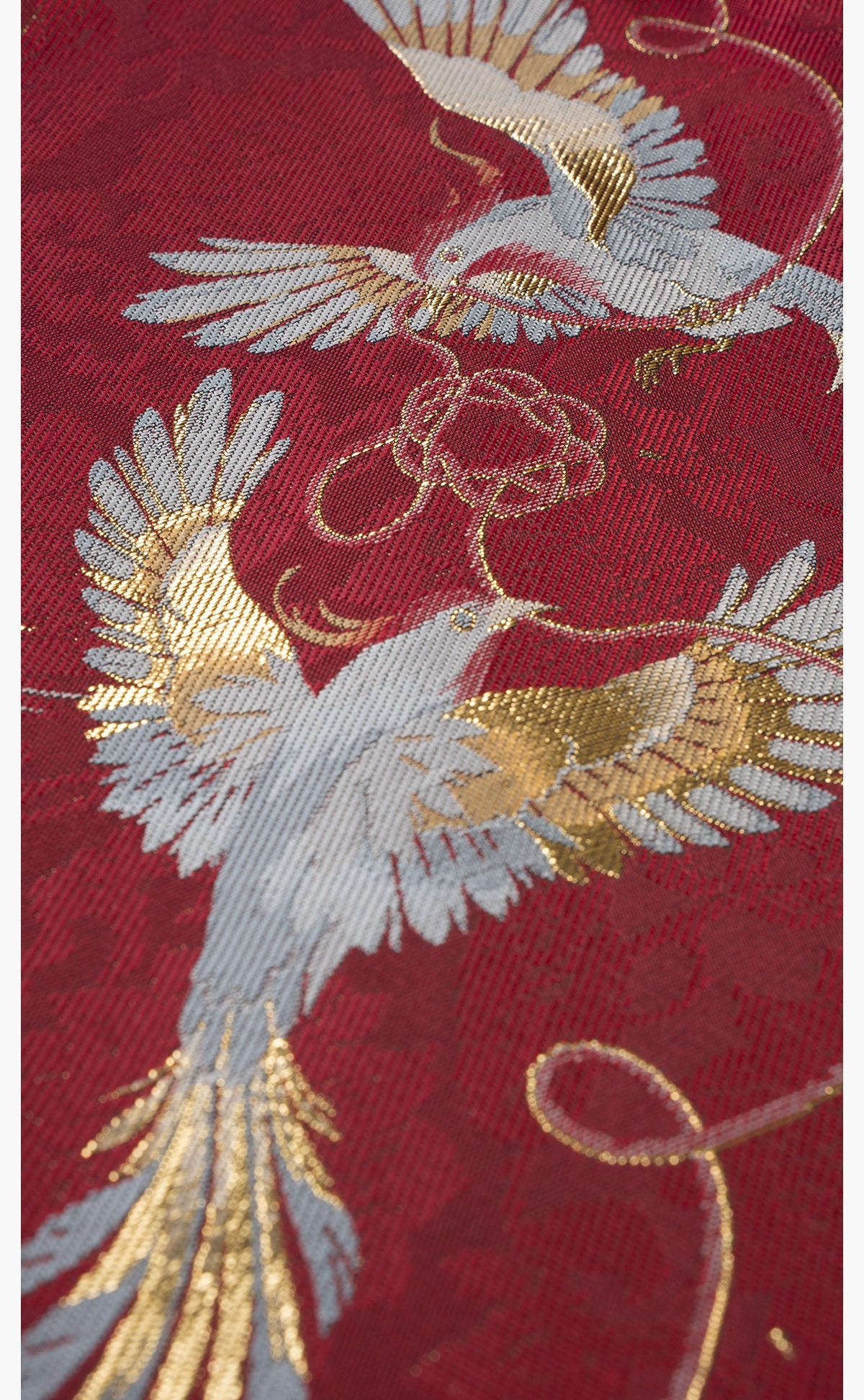 Bird and floral embroidery detail on [Dan Que Acacia] New Chinese Style Red Wedding Dress fabric in gold and silver thread.