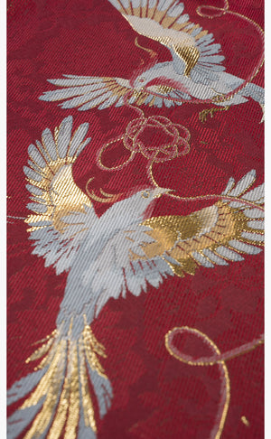 Bird and floral embroidery detail on [Dan Que Acacia] New Chinese Style Red Wedding Dress fabric in gold and silver thread.
