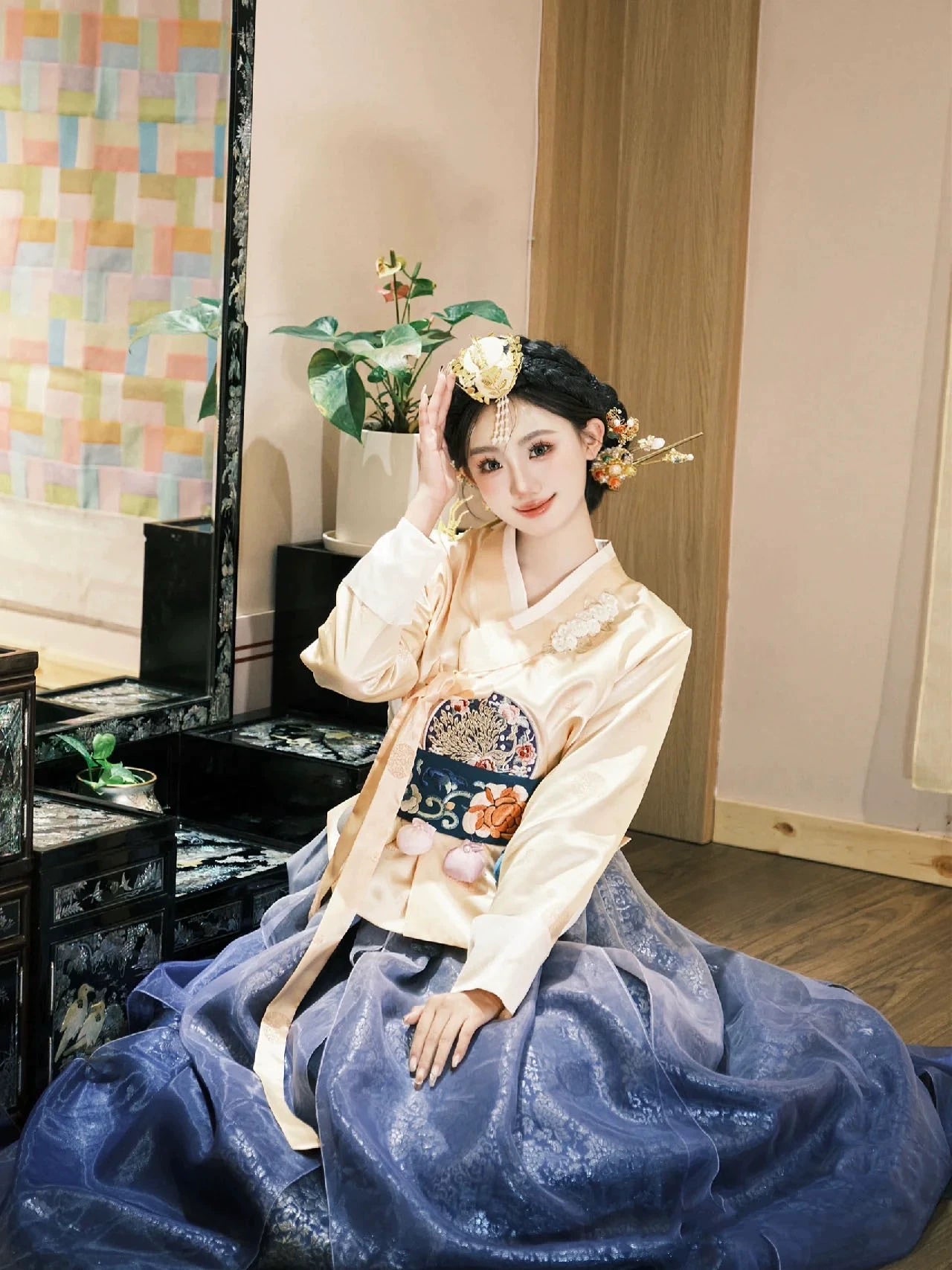 Elegant Korean Princess Hanbok in blue with gold accents, showcasing traditional craftsmanship and modern sophistication.