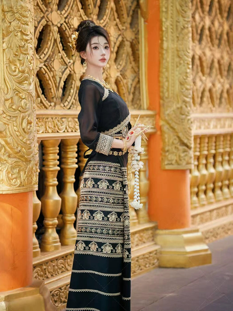 Black&Gold Dai skirt full set worn by female model in ornate temple setting, emphasizing traditional elegance and cultural heritage.