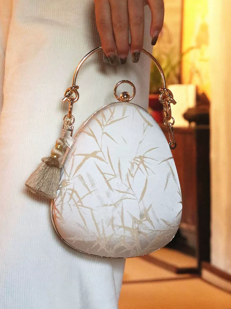 Front of the bamboo jacquard bag with gold-tone frame and tassel