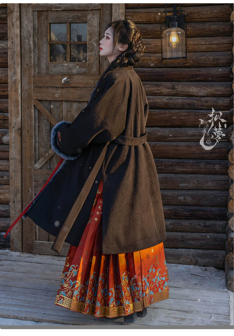 Back view of black woolen Hanfu coat with a belted design, floral embroidery, and faux fur cuffs, styled for traditional winter fashion.