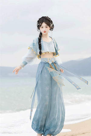 【Cloud Traveler】 Hanfu Princess Jasmine blue suit with gold embroidery, modeled barefoot on a beach with flowing ribbons.