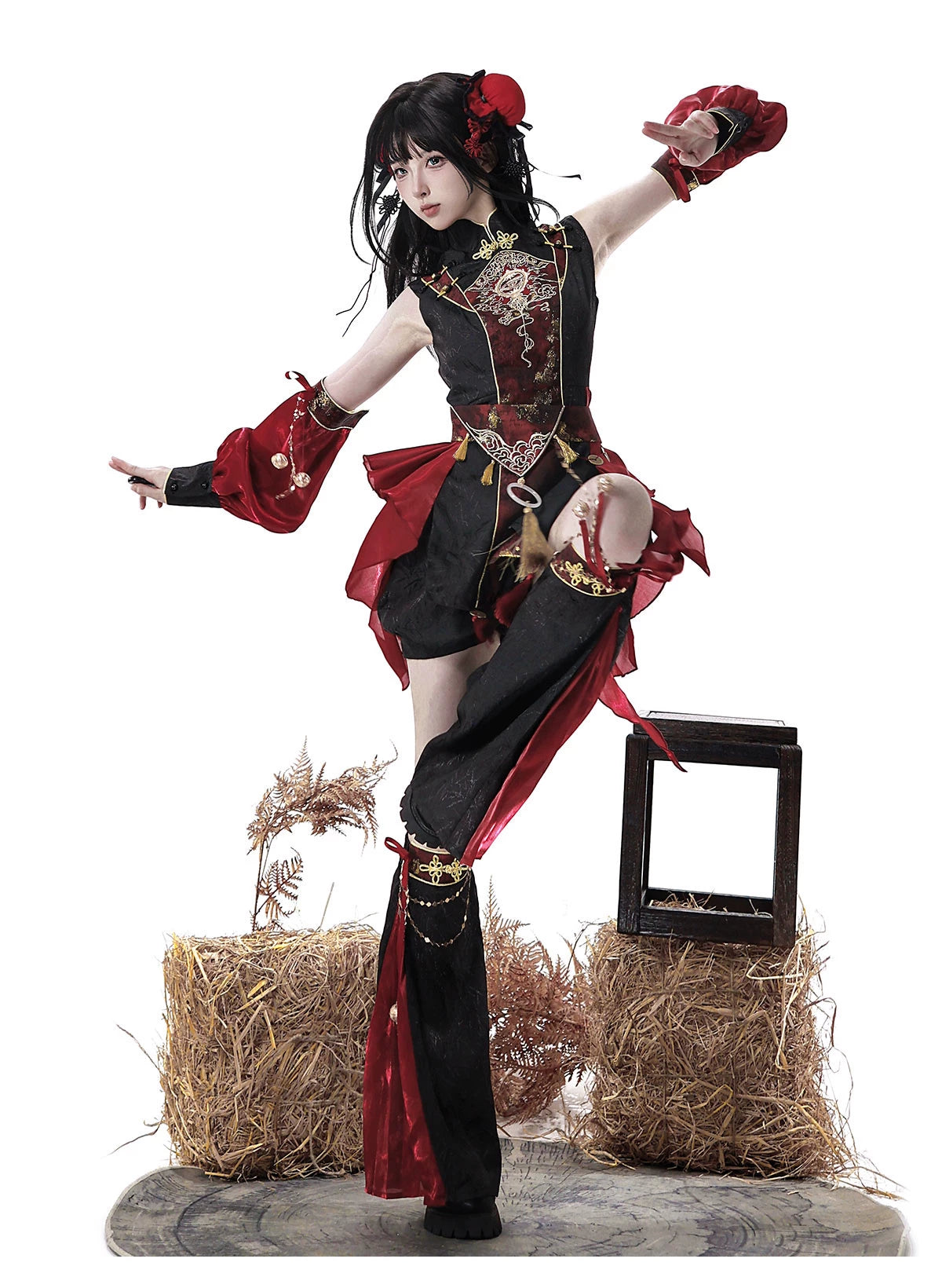 Red and black outfit styled in a raised-leg pose