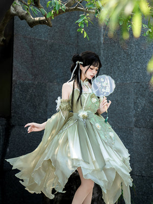 Model in Flower Marriage Green Lolita Dress holding a fan, showcasing the dress’s flowing design and floral embellishments.