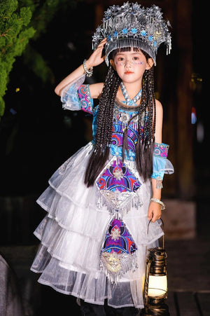 Authentic Miao Purple Clothing for Xinjiang girls featuring silver ethnic headwear and tiered dress for cultural stage performances.