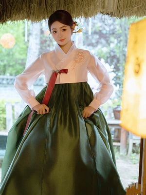 Elegant green Korean dance hanbok with floral details and traditional design.