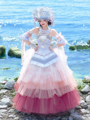 Full view of Pink Miao Clothing Women's Summer Cake Green Dress with pink ombre tulle and silver embellishments by the ocean.