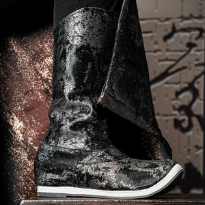 Close-up of gilt Hanfu boots with a metallic finish, highlighting their intricate design and cultural significance.