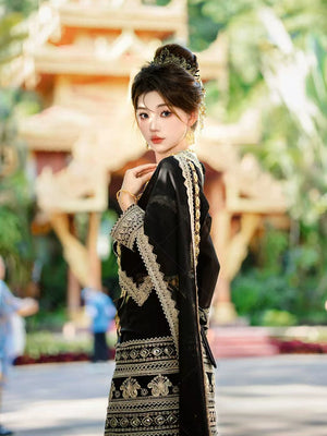 Traditional Black&Gold Dai princess outfit with gold detailing, styled for cultural fashion photography in a heritage location.
