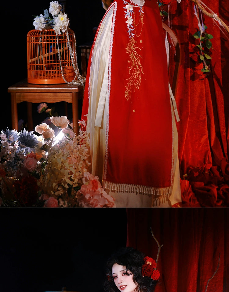 Red cheongsam dress with floral embroidery and cream pleated skirt, styled with a birdcage and floral decor for engagement events.