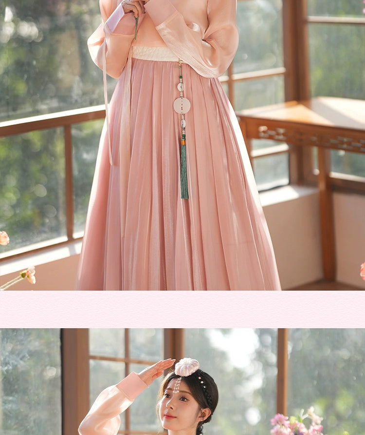 Traditional Korean hanbok dress in soft pink, featuring a flowing silhouette and delicate fabric. A timeless and elegant outfit.