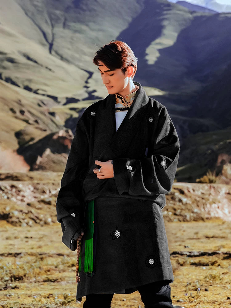 Men's black Kangba Tibetan robe with belt in mountain landscape