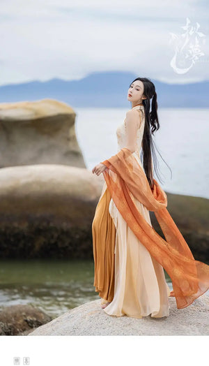 Model in cheongsam dress with orange shawl by water