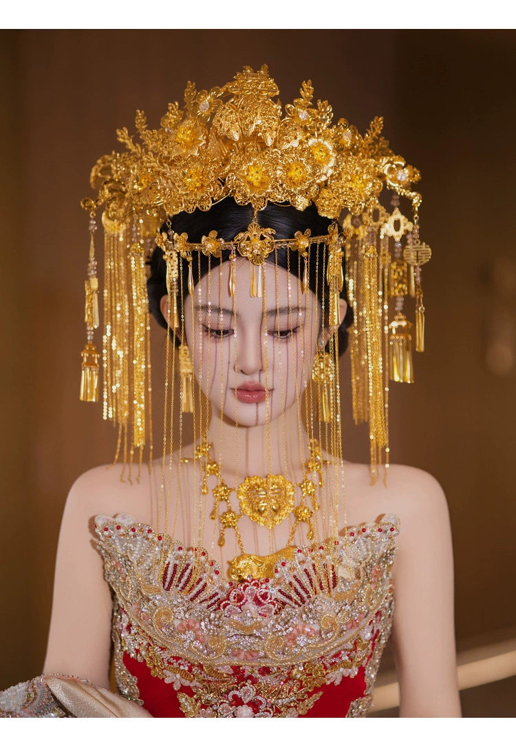Close-up of bride in golden curtain headdress and red embroidered gown, showcasing Chinese wedding hair accessories.