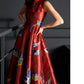 Detailed view of red satin cheongsam dress with intricate jacquard designs.