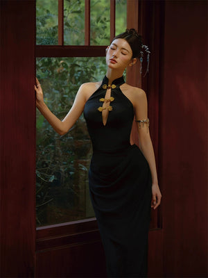 Black fishtail cheongsam dress with gold floral accents, styled with a halter neckline and elegant accessories.