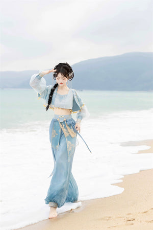 Walking along the beach in blue Hanfu Princess Jasmine suit by 【Cloud Traveler】, showcasing ethnic elegance and flowing fabric.