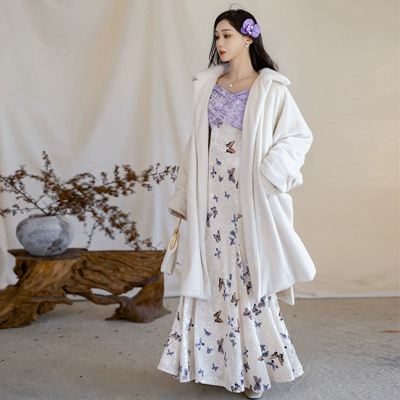 Full winter outfit featuring a white fur jacket layered over a butterfly-printed fishtail skirt with a purple velvet bodice.