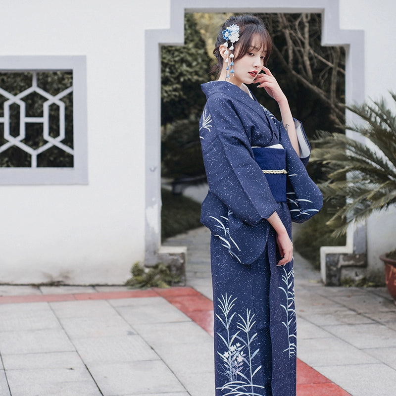 Side view of blue Japanese kimono yukata with white floral accents.