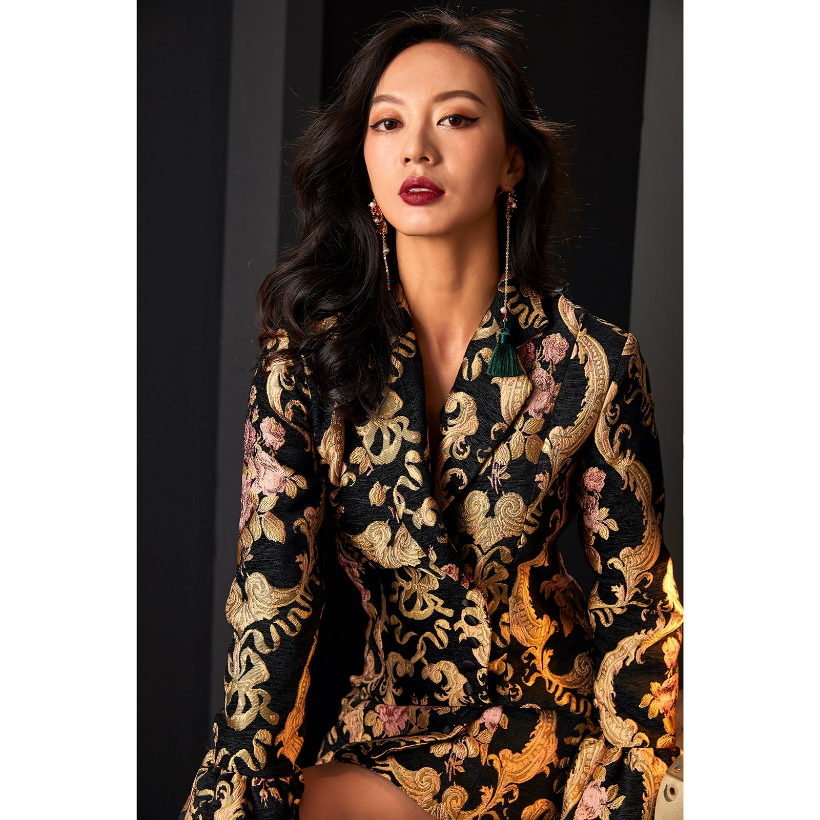 Detailed view of jacquard dress suit with intricate gold floral design.