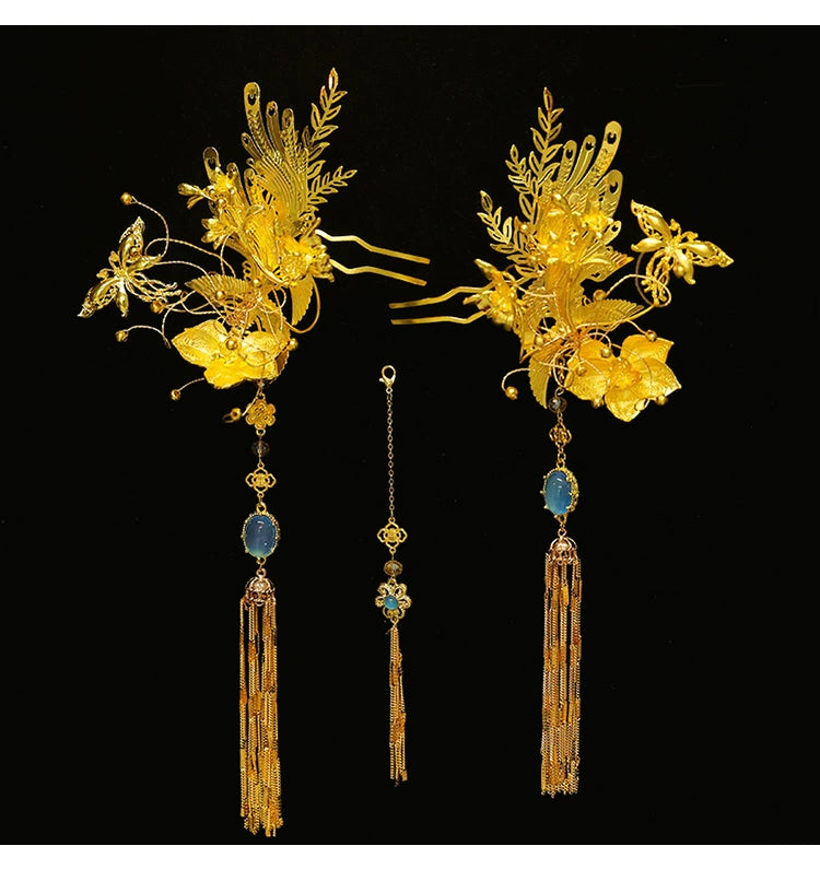 Flat lay of gold Chinese dragonfly hairpin set with blue stones and fringe, ideal for bridal cheongsam accessories.