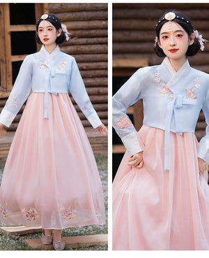 Stylish blue and pink hanbok with delicate floral embroidery, ideal for cultural events and special occasions.