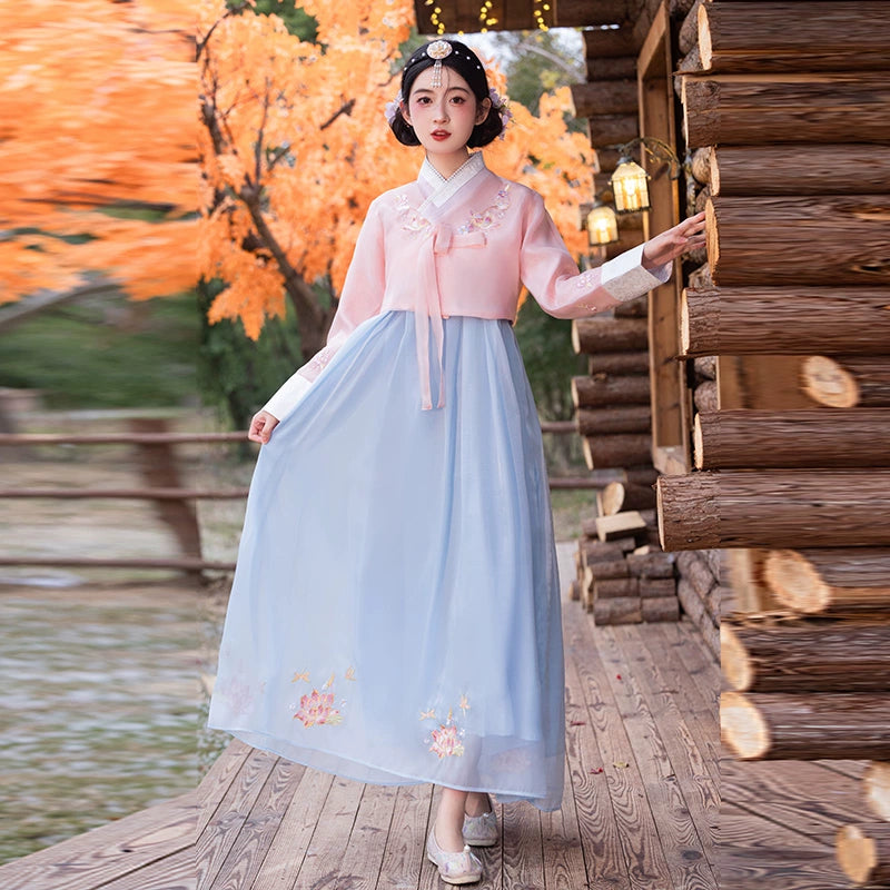 Reversible-style traditional Korean hanbok in pink and blue, adorned with floral embroidery for a graceful look.