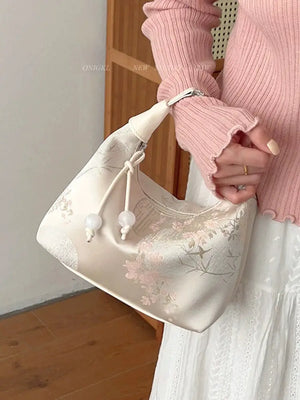 Complete your look with this elegant white cheongsam Bag, designed to complement both modern hanfu and traditional hanfu styles. Perfect for hanfu women, this bag adds charm to casual hanfu, hanfu cosplay, or layered hanfu outfits. A must-have hanfu accessory, it’s ideal for carrying essentials while maintaining an authentic style. Wondering where to buy qipao or accessories? Shop now at our trusted hanfu shop for the best modernised hanfu bags.