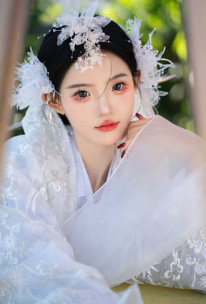 Ornate White&Pink hanbok Korean dress with floral headpiece, perfect for women’s high-end court performances and fashion shoots.
