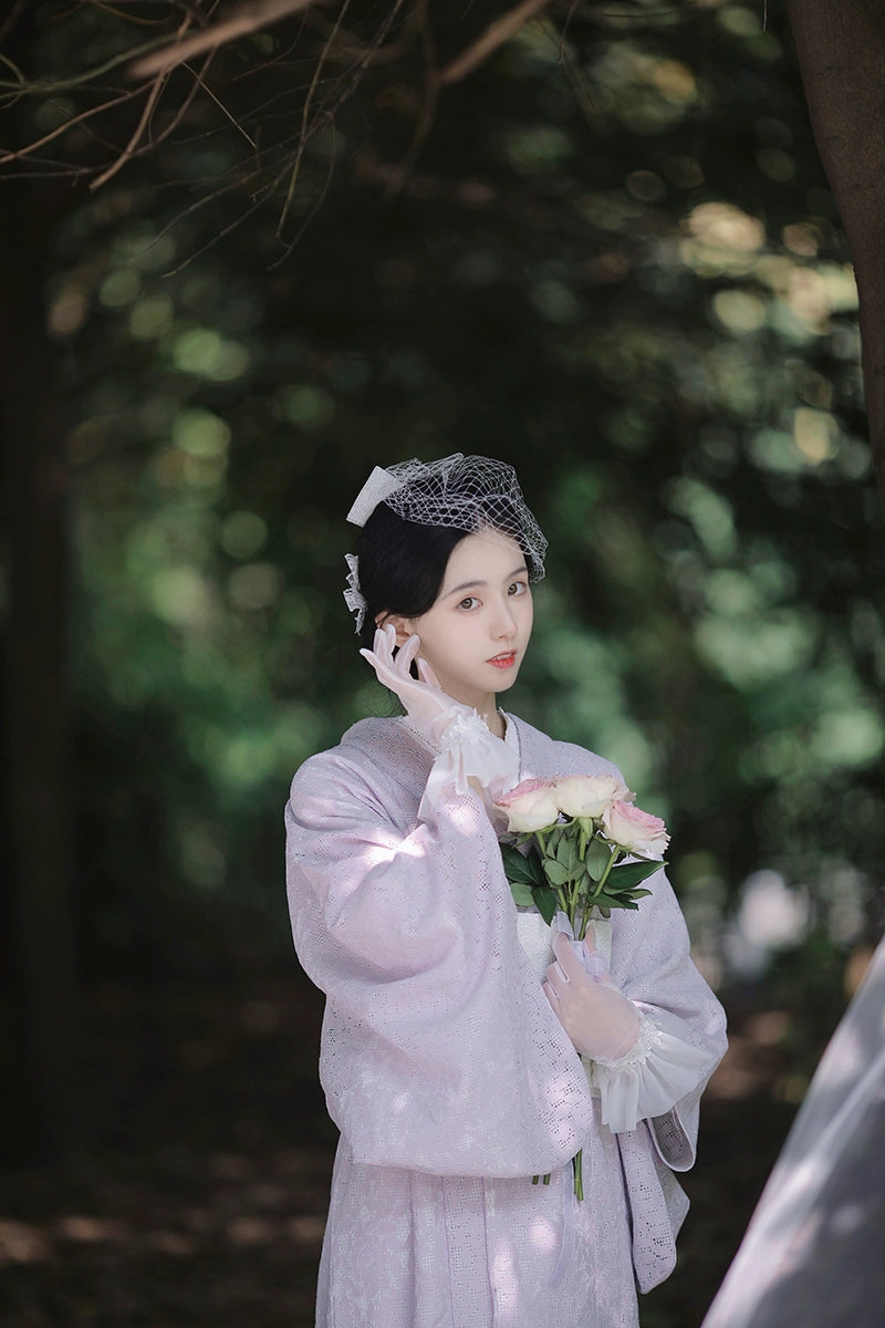 Purple lace kimono with a bouquet of roses in an elegant pose.