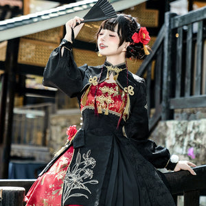 Model wearing a Lolita cheongsam suspender skirt set, holding a fan while displaying the detailed embroidery and gold embellishments on the outfit.