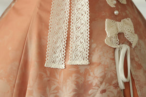 Fixed waist bows and decorative cord on the peach dress