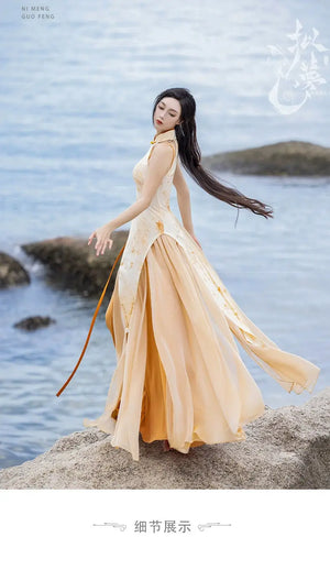 Woman in flowing cheongsam dress on rocky shore