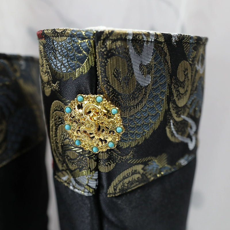 Close-up of gold decorative button and intricate embroidery on men's Hanfu wedding boots, showcasing traditional craftsmanship.