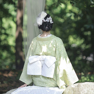 Back view of avocado green Taisho Roman kimono with white obi.