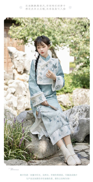 Graceful women's cheongsam with a pear blossom motif and elegant embroidery. A timeless and sophisticated outfit for cooler seasons.