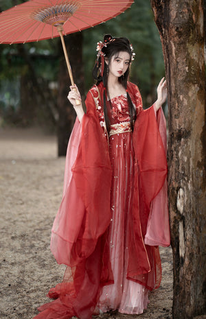 Step into the opulent world of Tang Dynasty elegance with our exquisite Red Hanfu Ensemble. Featuring a chest-length wrap skirt adorned with intricate super fairy embroidery and paired with a flowing large-sleeved top suit, our ensemble captures the essence of Tang Dynasty grandeur and sophistication. Embrace the rich heritage and timeless beauty of ancient Chinese fashion with our stunning collection.