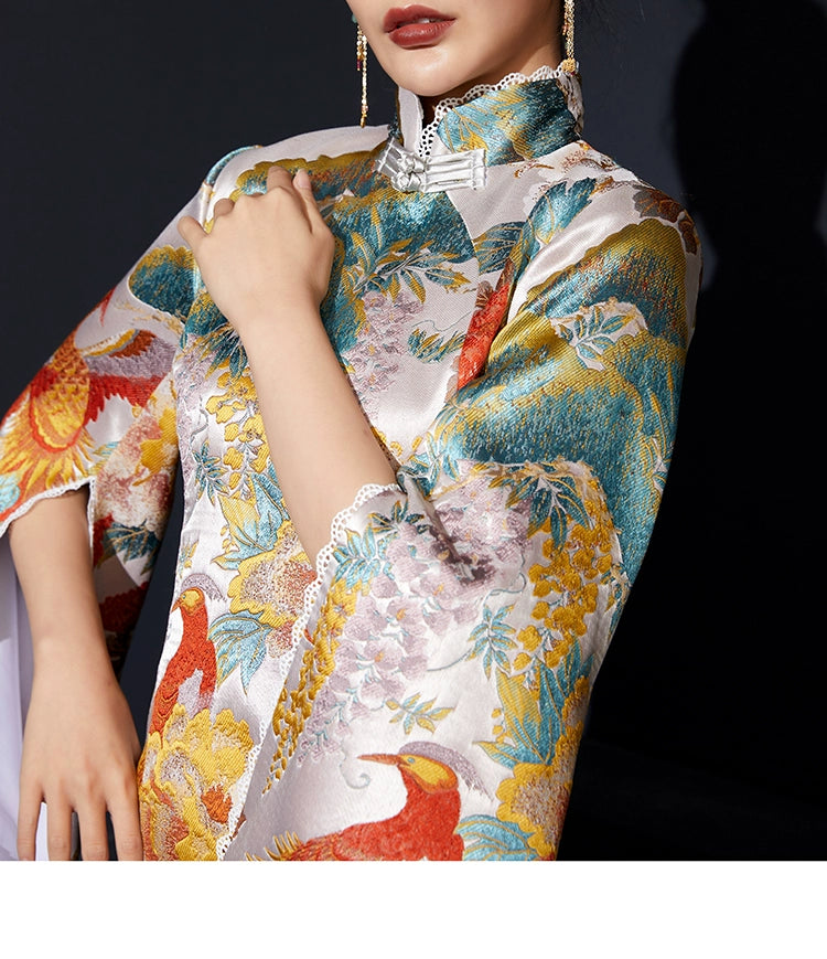 Detailed view of white phoenix cheongsam showcasing vibrant floral jacquard fabric.