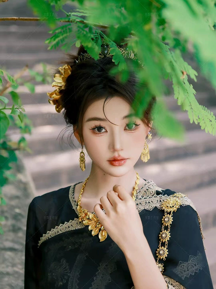 Close-up of Black&Gold Dai clothing female princess attire highlighting gold accessories and embroidery, showcasing traditional Dai craftsmanship.