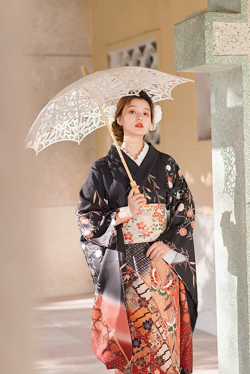 Retro black kimono with vibrant butterfly and floral patterns, styled with a parasol.