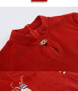 Close-up of red cheongsam dress collar with floral embroidery and keyhole detail, showcasing intricate craftsmanship.