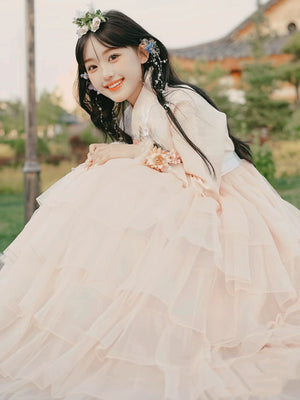 Beautiful pink Yanji dress with tiered skirt and delicate floral embellishments.