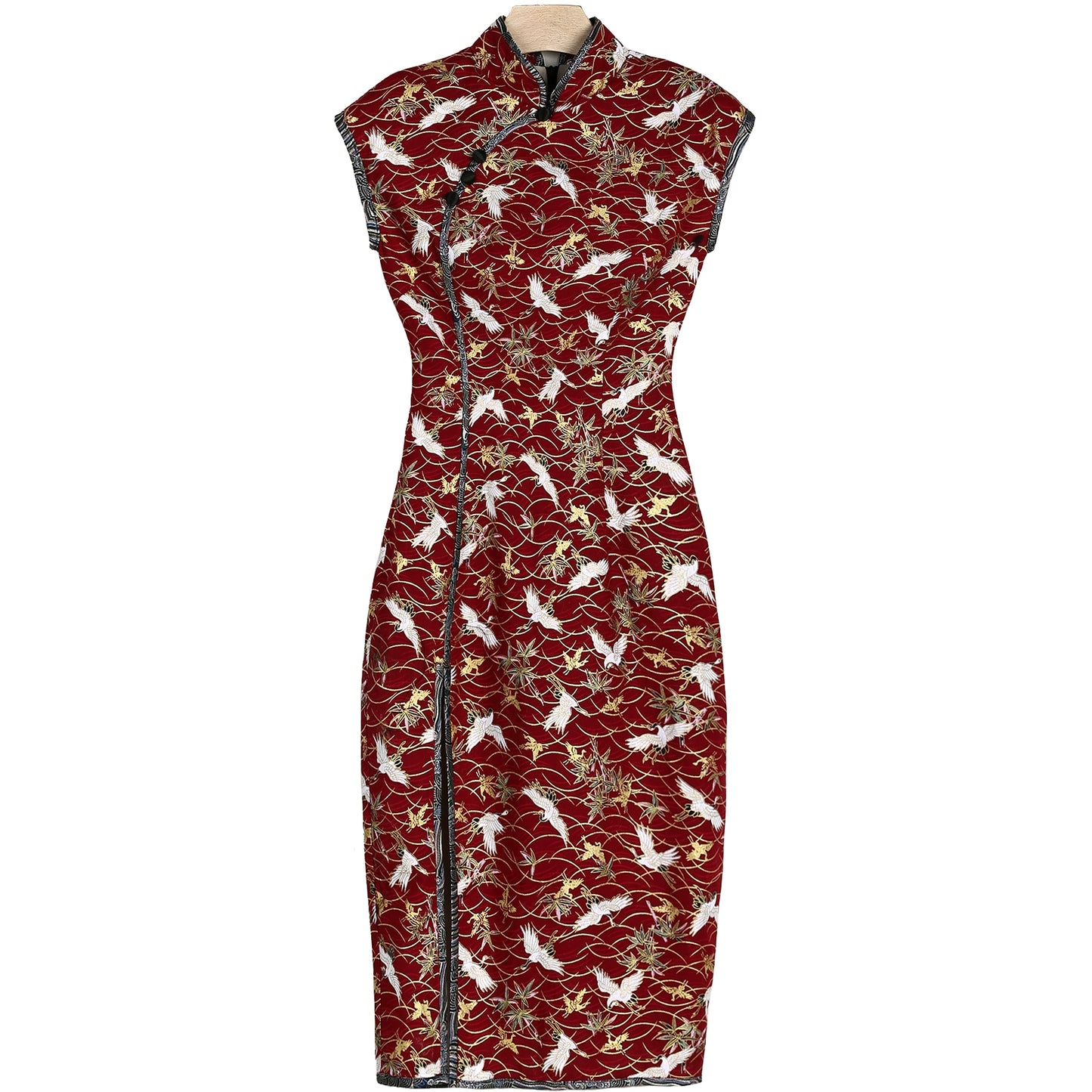 Full view of red cheongsam with crane print and elegant cotton fabric.