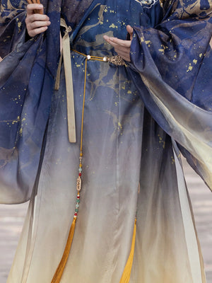 Detailed view of the Hanfu Printing Smudge Daoist Robe's flowing skirt, featuring gold tassel accessories and celestial-inspired embroidery.